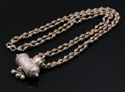Sterling silver amulet pendant with hanging bells and basil rosary beads necklace, handmade tribal jewelry from India.