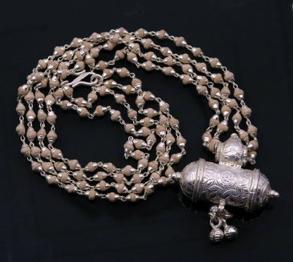 Sterling silver amulet pendant necklace with hanging bells and basil rosary beads, handcrafted tribal jewelry from India.