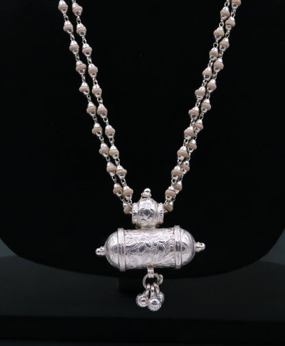Sterling silver amulet pendant with hanging bells and basil rosary beads, part of Tribal Ornaments jewelry set from India.