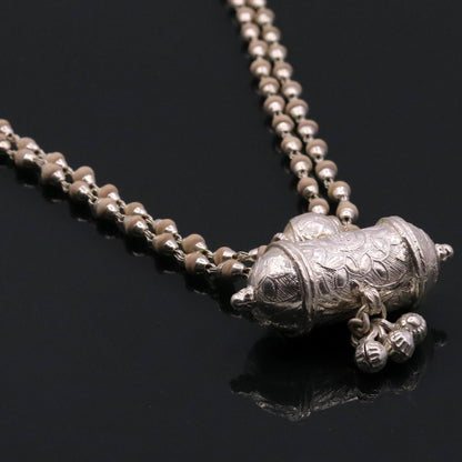 Sterling silver amulet pendant with hanging bells and basil rosary beads on a handcrafted necklace from Tribal Ornaments.