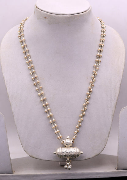 Sterling silver amulet pendant with hanging bells and basil rosary beads on a handcrafted Indian necklace by TRIBAL ORNAMENTS.