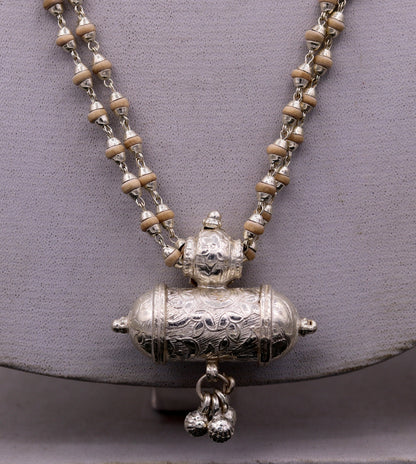 Sterling silver amulet pendant with hanging bells and basil rosary beads, part of Tribal Ornaments jewelry set from India.