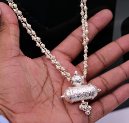 Sterling silver amulet pendant with hanging bells and basil rosary beads on a handcrafted necklace from Tribal Ornaments.