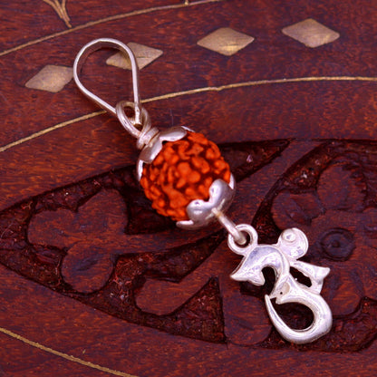 Sterling silver Aum pendant with natural rudraksha bead on a unisex necklace, handmade tribal jewelry by TRIBAL ORNAMENTS.