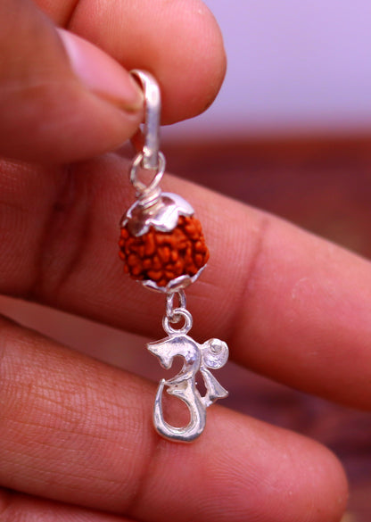 Sterling silver Aum pendant necklace featuring a natural Rudraksha bead, unisex tribal jewelry by TRIBAL ORNAMENTS.