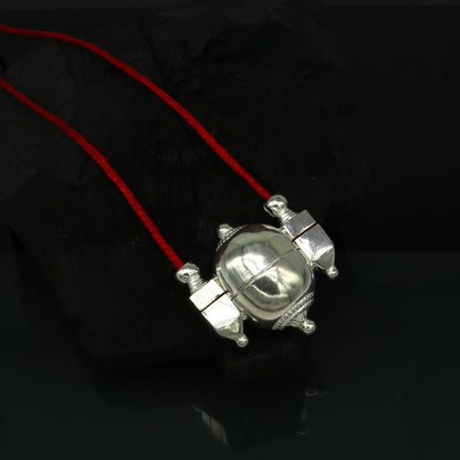 Sterling silver vintage Shiva Lingam pendant in a stylish casket box, crafted by TRIBAL ORNAMENTS, featuring intricate ethnic design.