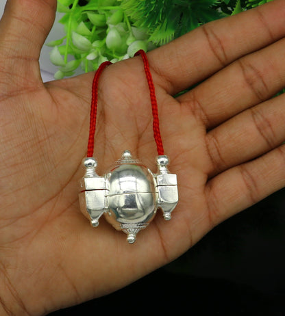 Sterling silver vintage Shiva Lingam pendant in a designer idol box, crafted by TRIBAL ORNAMENTS, with intricate ethnic details.