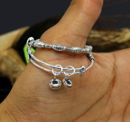 Sterling silver designer baby adjustable bangles bracelet with charm, handmade by TRIBAL ORNAMENTS, for kids.