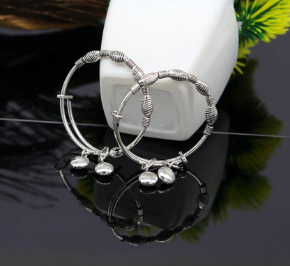 Sterling silver designer baby adjustable bangles bracelet with charms, handmade by Tribal Ornaments, for stylish kids jewelry.
