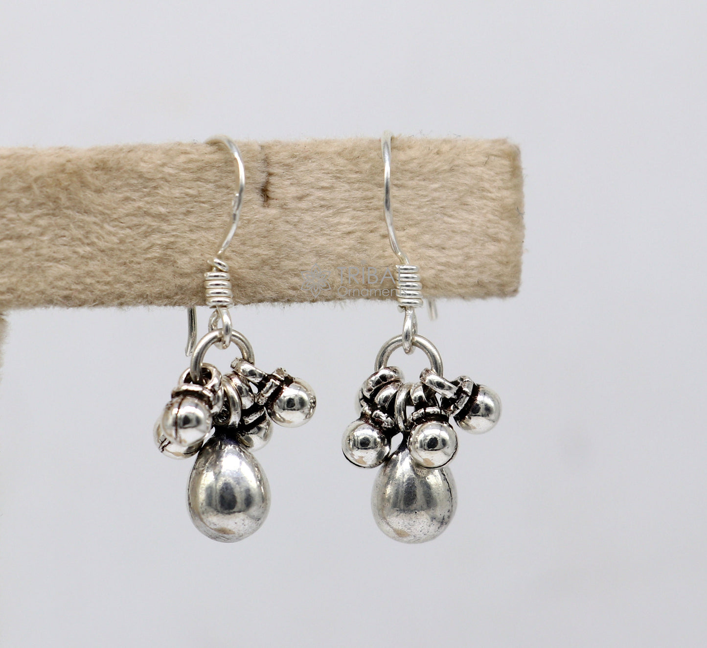 Traditional tribal-style 925 sterling silver hoop earrings with hanging drop dangles, custom-designed tribal jewelry.