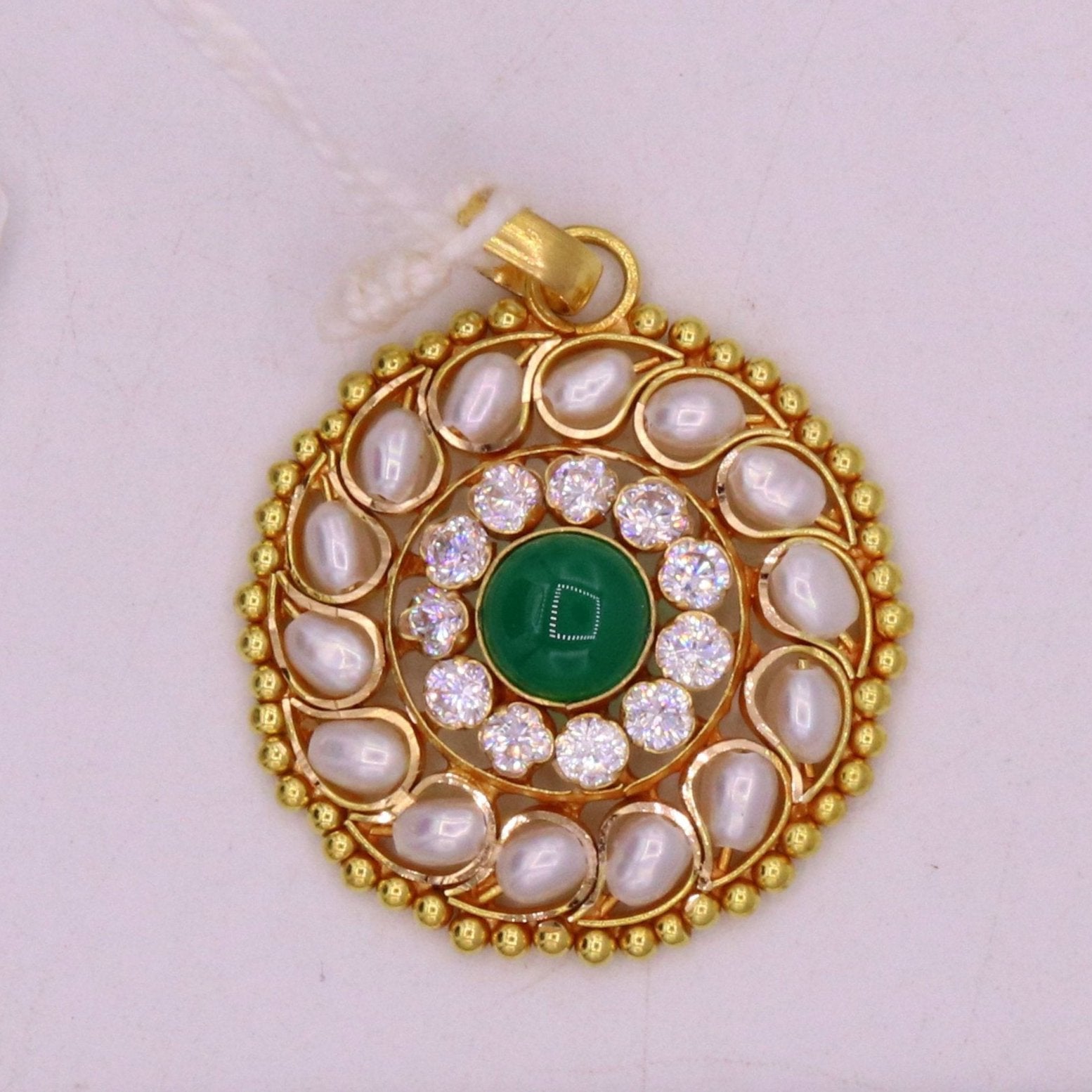 Vintage 22K yellow gold pendant with white pearl and green stone in Jadau style, handcrafted Indian jewelry with intricate design.