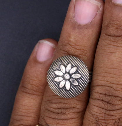 Handmade silver tribal ring with floral design from Rajasthan, India, featuring adjustable fit and intricate tribal jewelry craftsmanship.