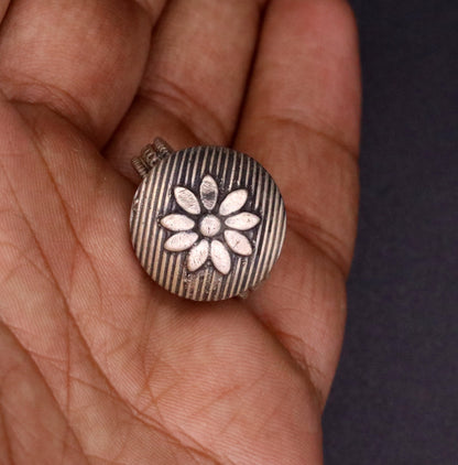 Traditional handmade silver flower-shaped tribal ring from Rajasthan, India, featuring adjustable fit and intricate craftsmanship.