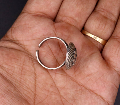 Traditional handmade silver flower-shaped tribal ring from Rajasthan, India, featuring adjustable design and intricate craftsmanship.