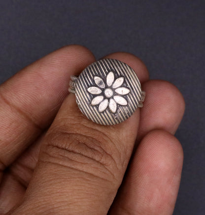 Traditional handmade silver flower-shaped tribal ring from Rajasthan, India, featuring adjustable design and intricate jewelry craftsmanship.