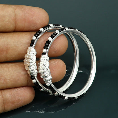 Sterling silver baby bangle with black evil eye design by TRIBAL ORNAMENTS, trendy tribal jewelry for newborns and kids.