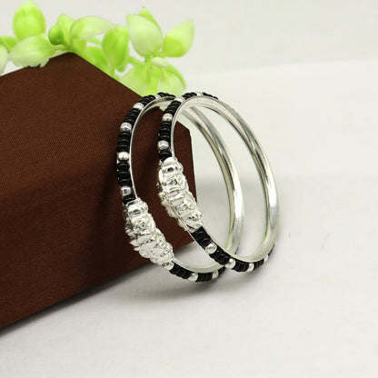 Sterling silver baby bangle with black evil eye design, trendy jewelry for newborns and kids from Tribal Ornaments India.