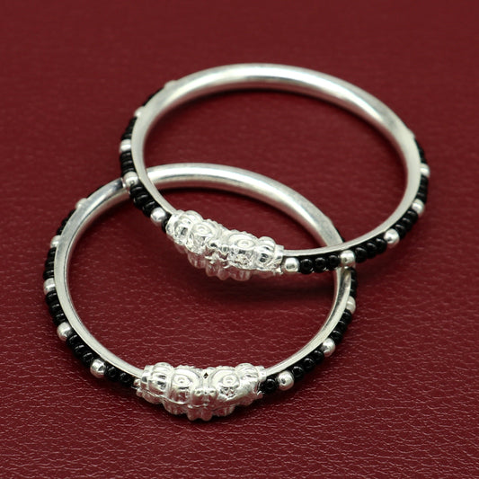 Sterling silver baby bangle with black evil eye design, trendy tribal jewelry for newborns and kids from Tribal Ornaments.