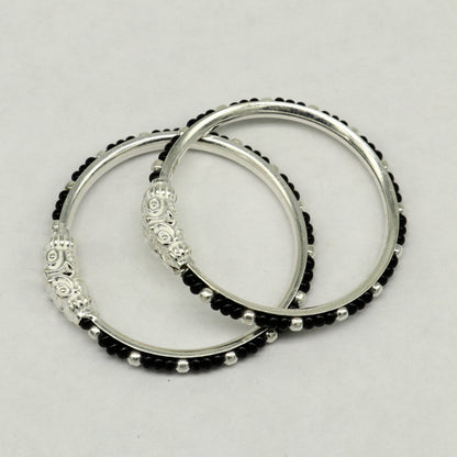 Sterling silver baby bangle with black evil eye design, tribal style jewelry for newborns and kids from Tribal Ornaments.