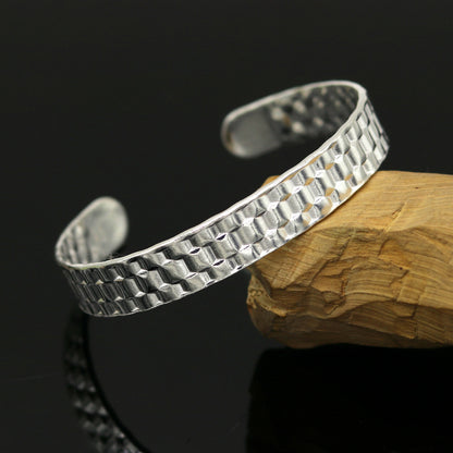 Vintage sterling silver open face adjustable bangle bracelet by Tribal Ornaments, unisex custom jewelry with intricate antique design.