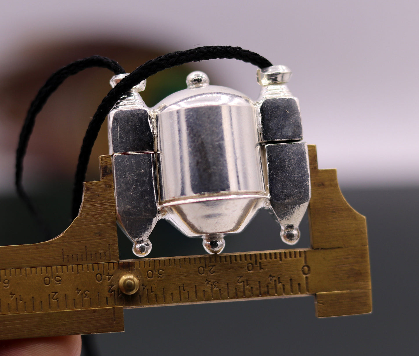 Vintage sterling silver Lord Shiva Lingam pendant in a decorative box container, featuring traditional Indian tribal jewelry design.