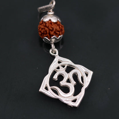 Vintage solid silver Aum pendant with natural Rudraksh beads, handmade tribal jewelry, intricate antique design.