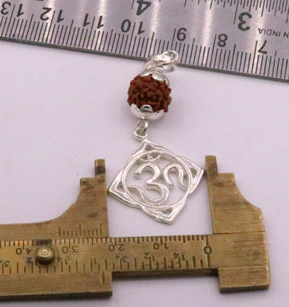 Vintage solid silver Aum pendant with natural Rudraksh beads, handmade tribal jewelry design.