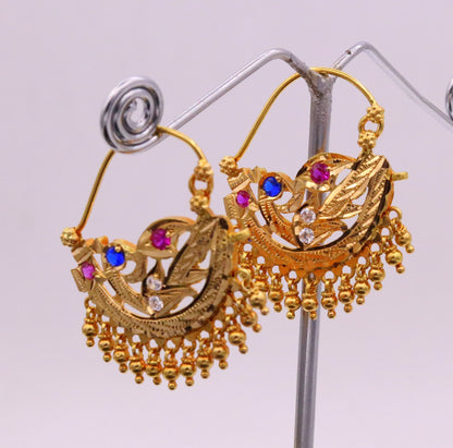Vintage antique 22K yellow gold tribal-style hoop earrings with hanging bells, handmade traditional Indian jewelry.