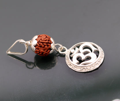 Vintage solid silver Aum pendant with natural Rudraksh beads, handcrafted tribal jewelry piece.