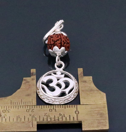 Vintage solid silver Aum pendant with natural Rudraksh beads, handcrafted tribal jewelry, intricate religious symbol design.