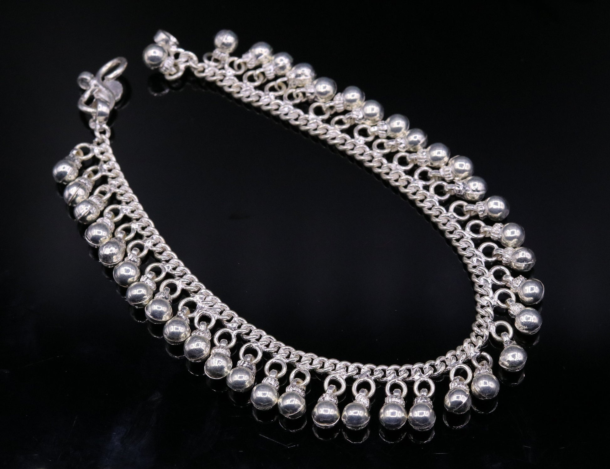 Vintage sterling silver ankle bracelet with handmade chain and jingle bells, featuring tribal design and genuine jewelry craftsmanship.