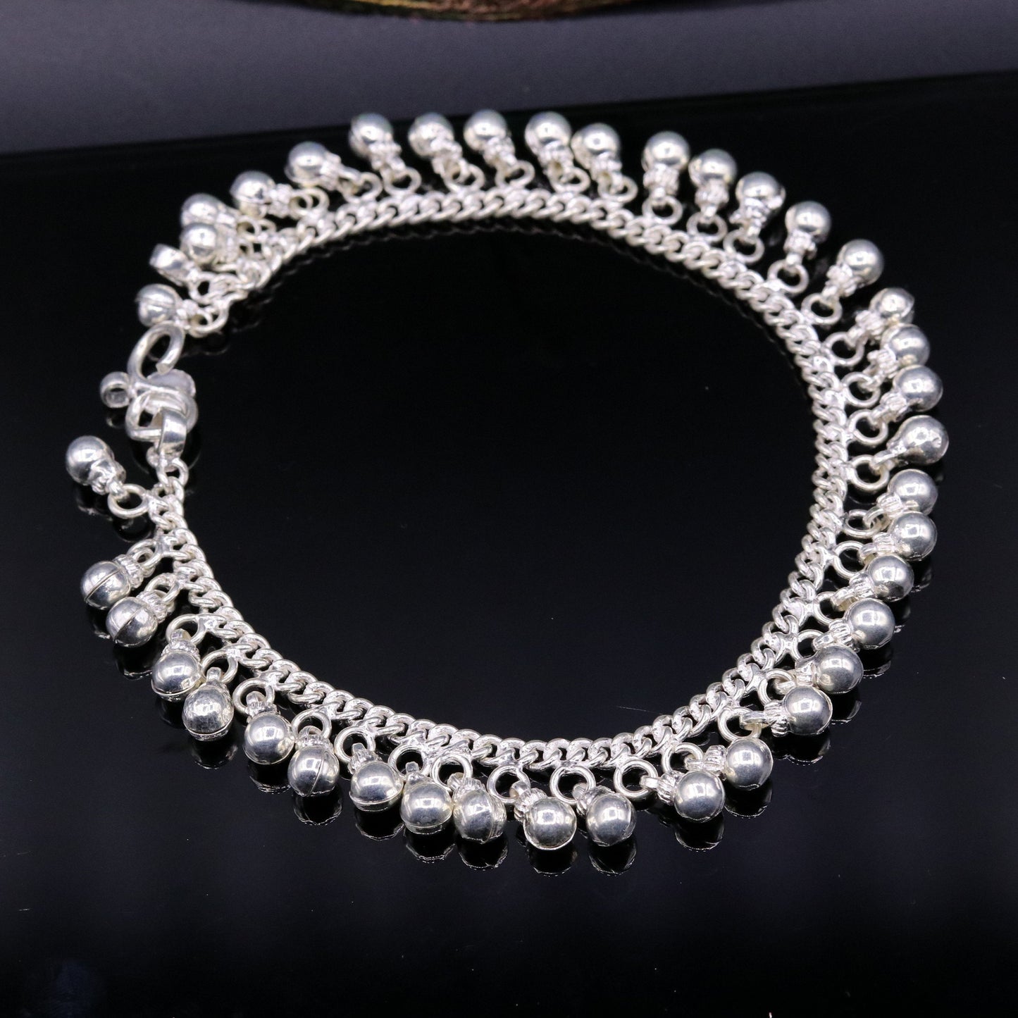 Vintage sterling silver ankle bracelet with handmade chain and jingling bells, featuring authentic tribal jewelry style.