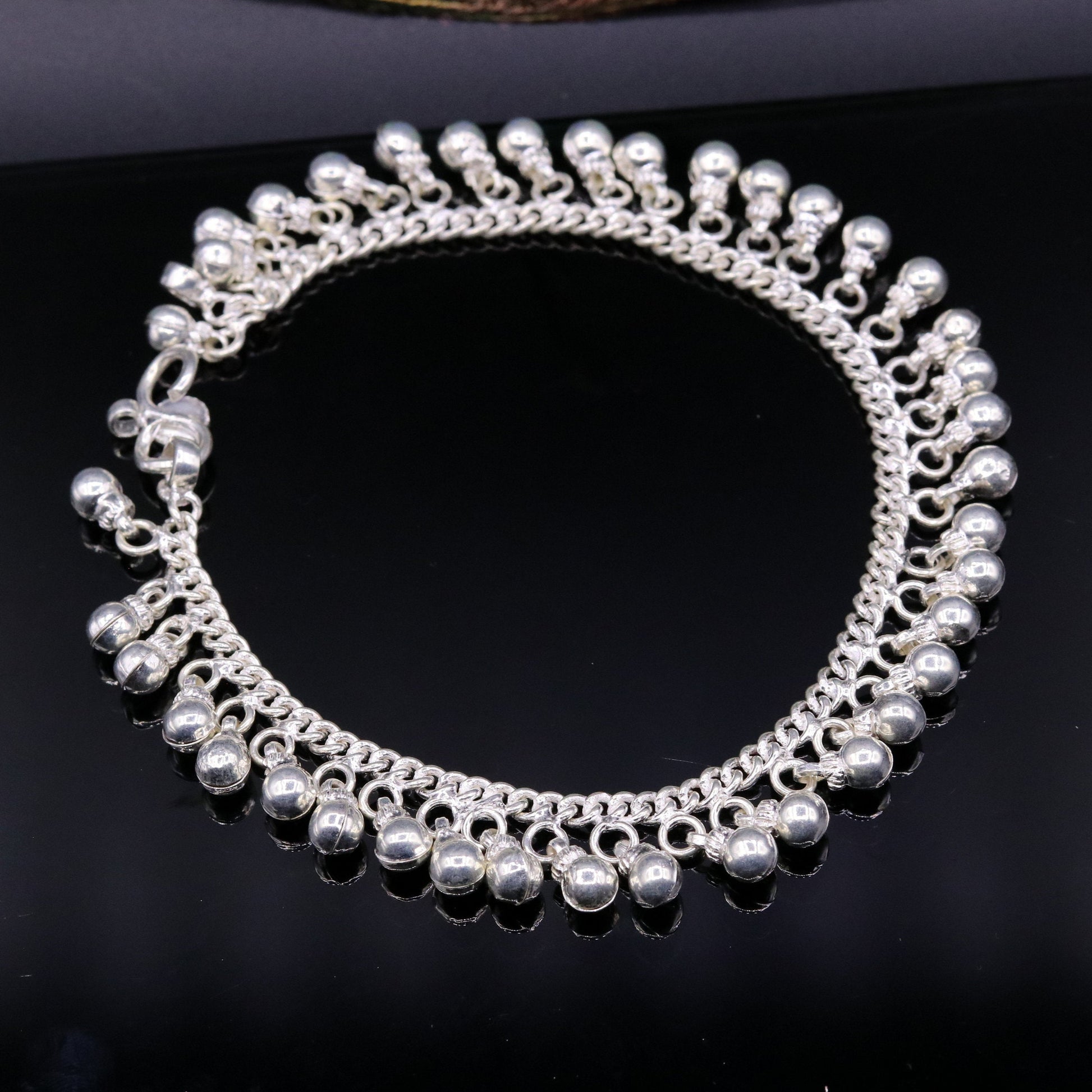 Vintage sterling silver ankle bracelet with handmade chain and jingling bells, featuring authentic tribal jewelry style.