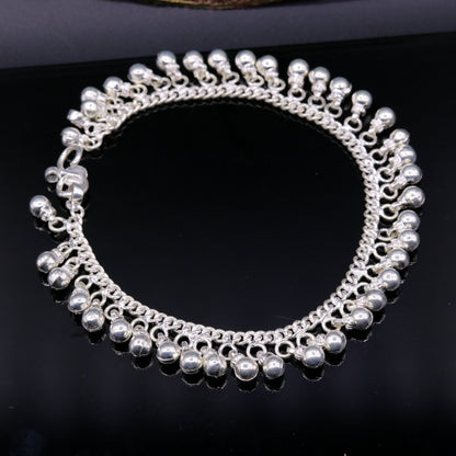 Vintage sterling silver ankle bracelet with handmade chain and jingling bells, featuring authentic tribal jewelry style.