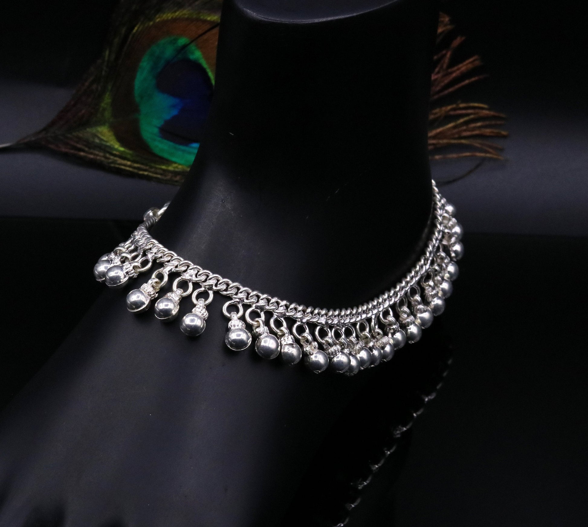 Vintage sterling silver ankle bracelet with handmade chain and noisy jingle bells, featuring tribal-inspired design and genuine jewelry details.