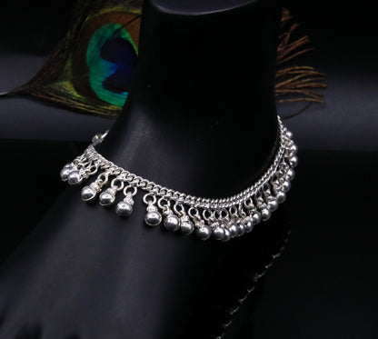 Vintage sterling silver ankle bracelet with handmade chain and noisy jingle bells, featuring tribal-inspired design and genuine jewelry details.
