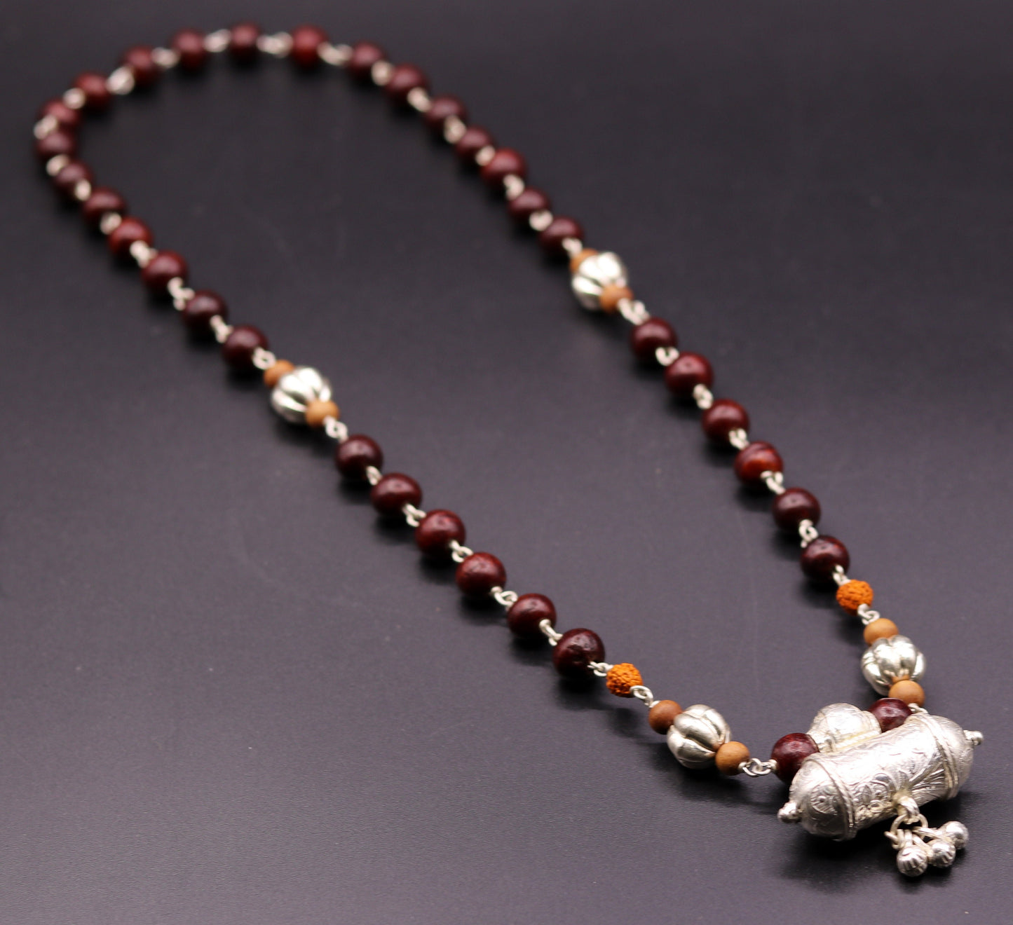 Vintage tribal jewelry set featuring solid silver sandalwood and Rudraksha beads with a pendant and hanging bells.