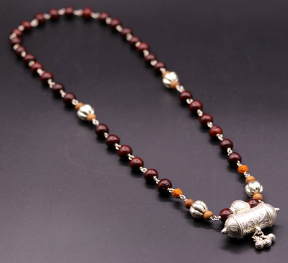 Vintage tribal jewelry set featuring solid silver sandalwood and Rudraksha beads with a pendant and hanging bells.