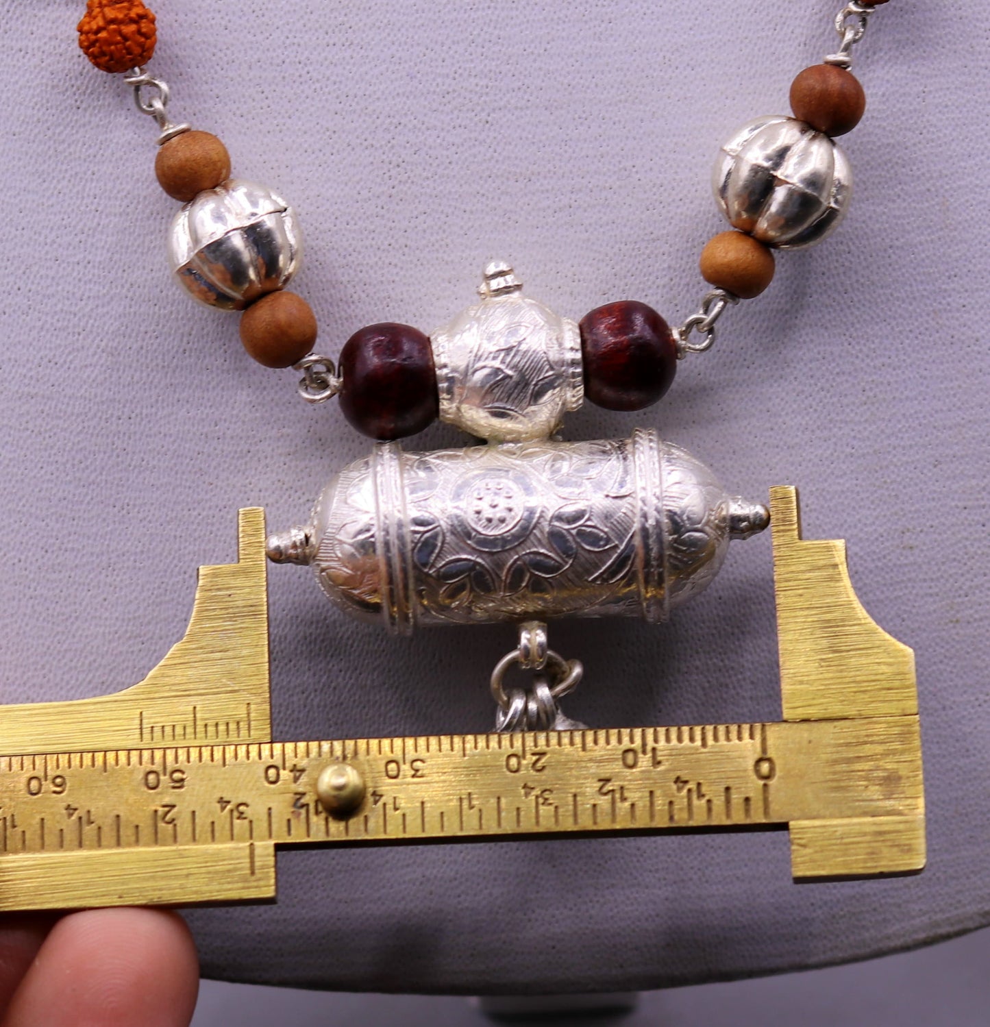 Vintage tribal silver necklace set with sandalwood, Rudraksha beads, amulet pendant, and hanging bells by TRIBAL ORNAMENTS.