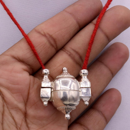 Solid silver Lord Shiva Lingam box pendant with vintage tribal design, serving as amulet container or mantra jewelry.