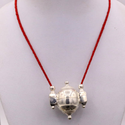Vintage silver Lord Shiva Lingam box pendant, tribal jewelry casket with engraved design and symbolic mantra storage.