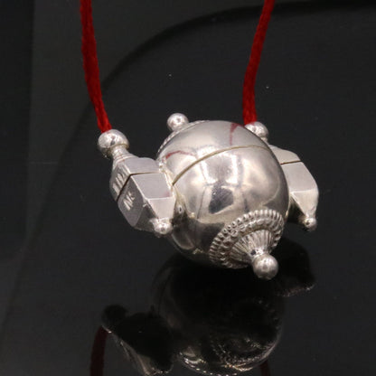 Vintage tribal silver Shiva Lingam box pendant with intricate designs, used as prayer or mantra box in traditional jewelry.