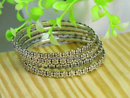 Vintage flower design sterling silver bangle bracelet by TRIBAL ORNAMENTS, featuring oxidized tribal jewelry style.