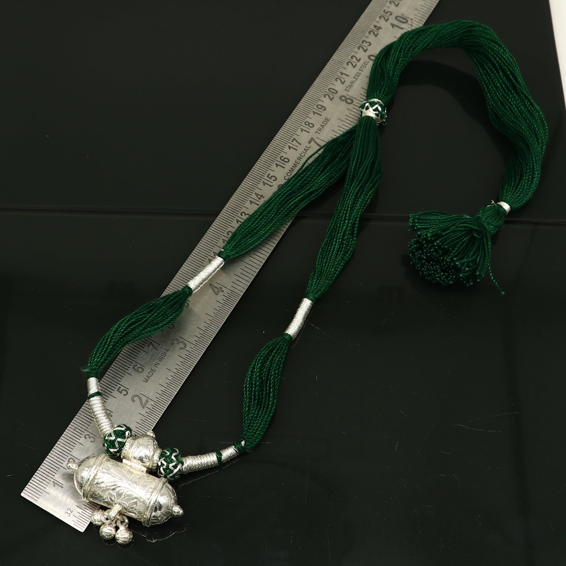 Vintage Indian silver charm necklace with green thread, traditional tribal wedding jewelry, ethnic tribal ornaments.