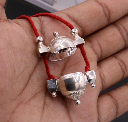 Handmade silver Shiva pendant in vintage mantra box, tribal jewelry container with intricate tribal ornament details.