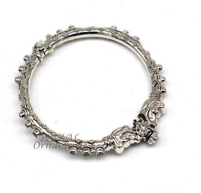 Sterling silver elephant face bangle bracelet by TRIBAL ORNAMENTS, unisex handmade jewelry with shiny vintage design.