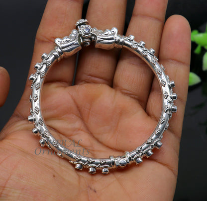 Sterling silver elephant face bangle bracelet by Tribal Ornaments, unisex handcrafted wrist jewelry with shiny finish and customized design.