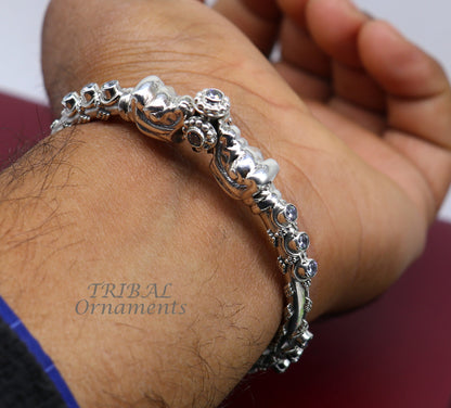 Sterling silver elephant face bangle bracelet by Tribal Ornaments, unisex handmade jewelry with shiny vintage design and customizable fit.