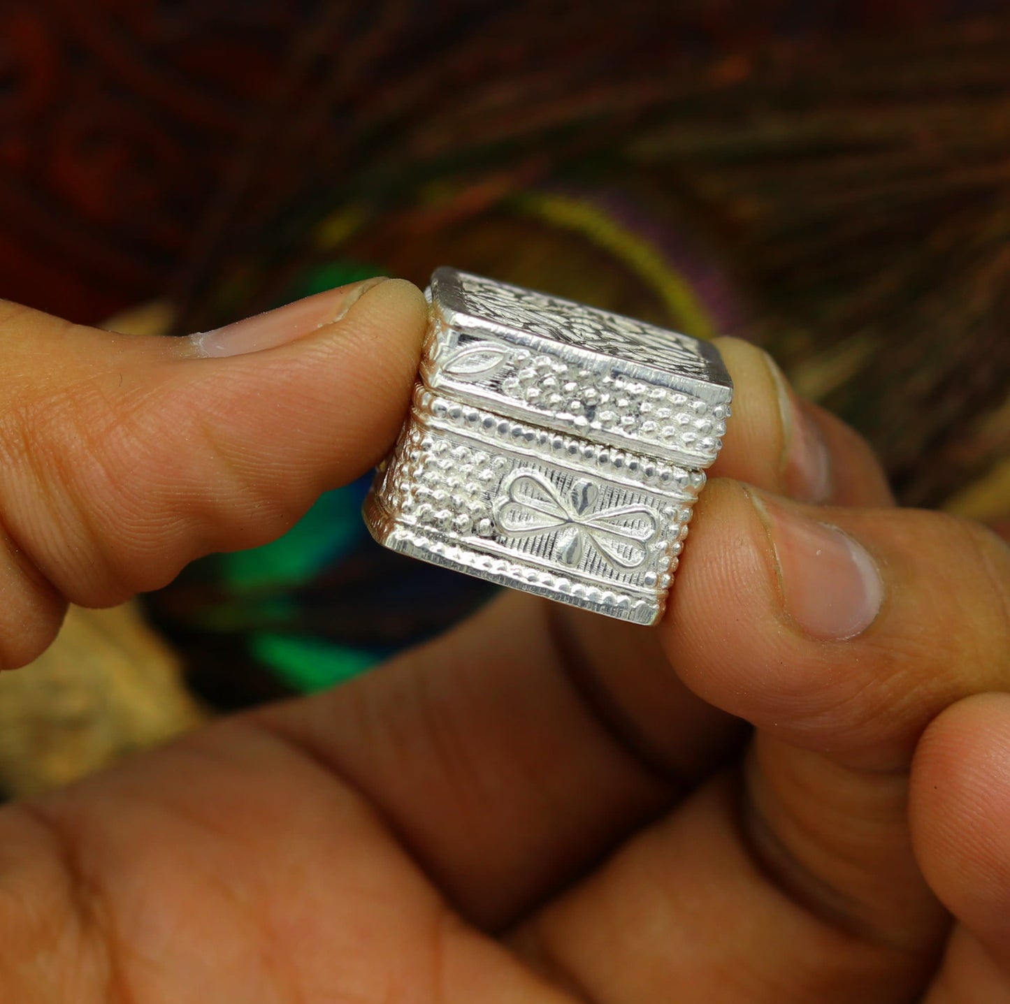 Vintage style small sterling silver bridal queen jewelry or eyes kajal trinket box with intricate tribal ornament details.