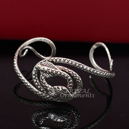 Sterling silver snake couple design bangle cuff bracelet by TRIBAL ORNAMENTS, vintage-style unisex jewelry with cobra motif.